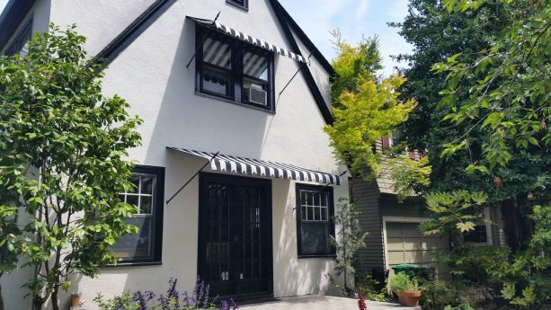 canvas awning with black and white striped fabric for a timeless front door