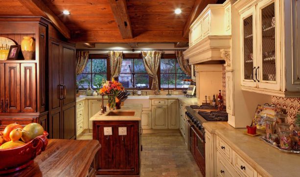 mediterranean kitchen with a cozy look from the white distressed cabinet and brick floor