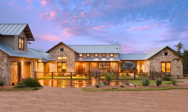 example of ranch style stone exterior home design with vinyl siding and metal roof