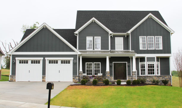 mid-size elegant two-story ranch style house with a lovely vinyl siding