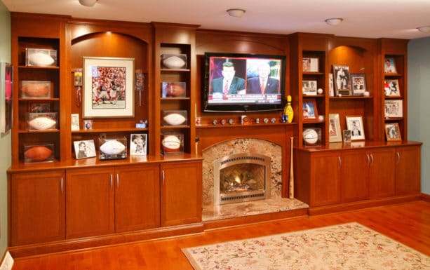 classic living room with wood wall unit decorative shelving and marble fireplace