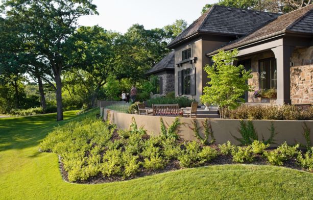 low stucco retaining wall in steep grass slopes