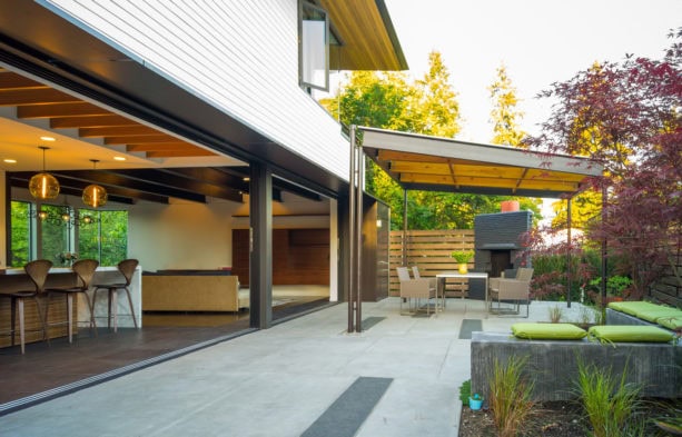 concrete covered patio with ledgestone fireplace