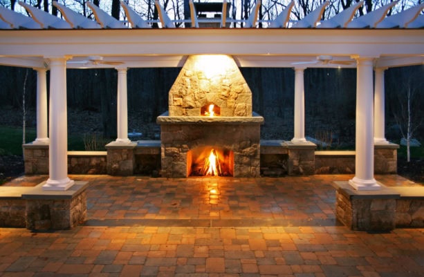 united but separated stone surround outdoor fireplace and pizza oven