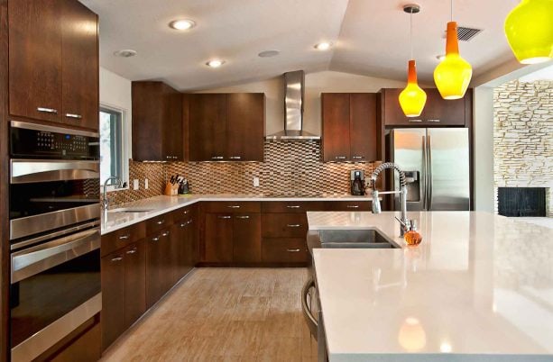 dark tone wood kitchen cabinets and light polished countertops in a mid-century kitchen