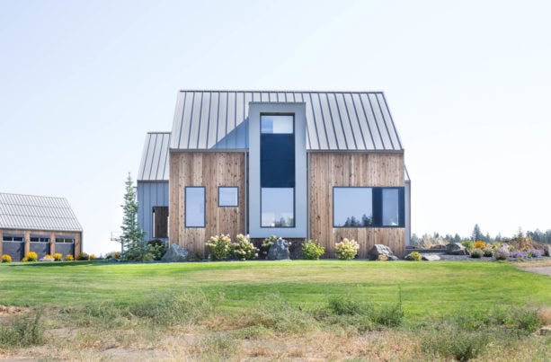 modern aesthetic house with color combination of zinc gray metal roof and vertical cedar siding