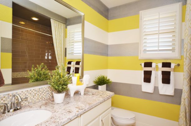 stripe bathroom wall design with yellow, white, and grey colors