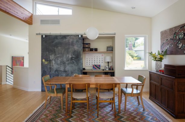 long wood dining table as a desk in a mid-century dining room doubling as a home office