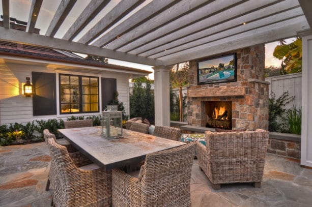 transitional stone patio and fireplace completed with a flat screen tv