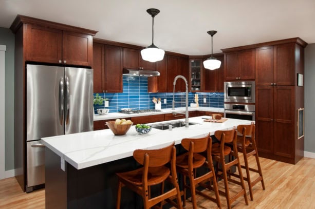 unique combination of blue backsplash kitchen color and dark brown shaker cabinets to give a calming sensation