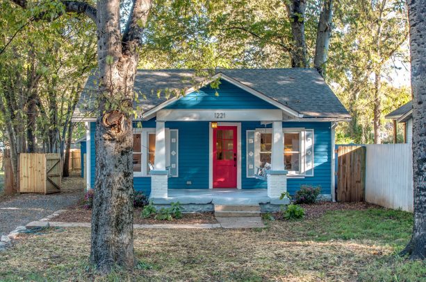 coral front door with blue siding