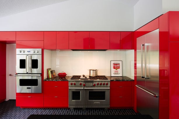 red contemporary kitchen with black subway tile flooring