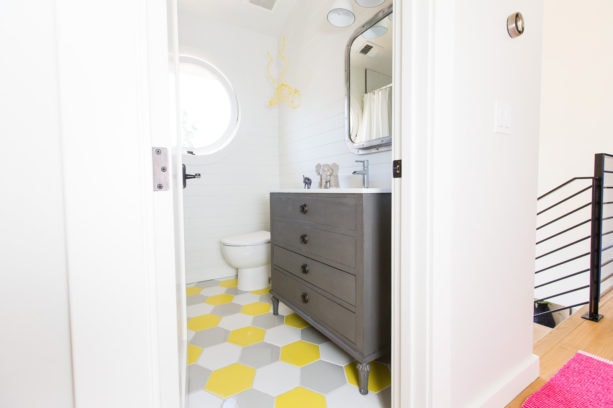 a transitional bathroom with fun multicolor hexagonal tile floor