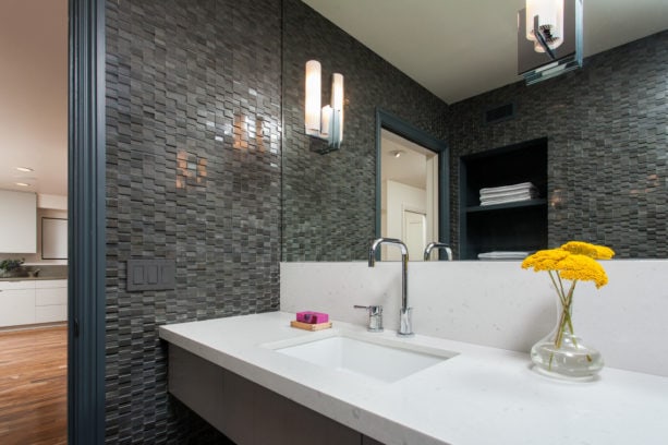 simple yet catchy flower decoration in grey bathroom with mosaic tile