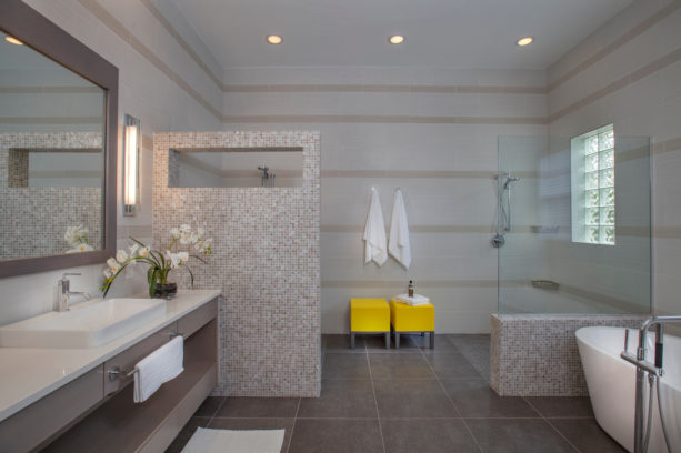 two catchy yellow stools in a grey contemporary bathroom