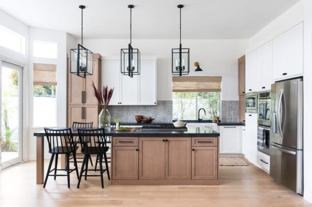 three colored cabinets in white, brown, and black countertops in a transitional kitchen