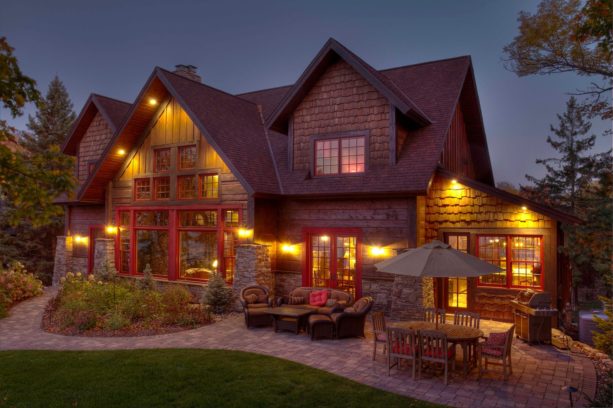 homely two-story wood exterior cabin with marvin wineberry color windows