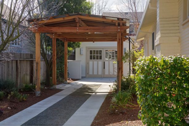 traditional post and beam carport in front of a garage