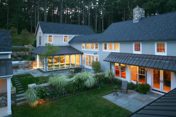 asphalt and copper metal roof color combination in a stained clapboard siding house