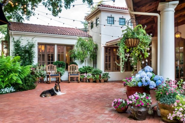 large mediterranean courtyard brick in a beige spanish style home