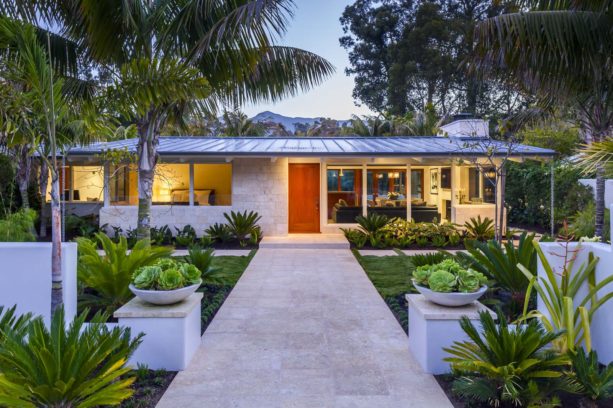 perfect house color combination of standing seam metal roof and neutral color stone