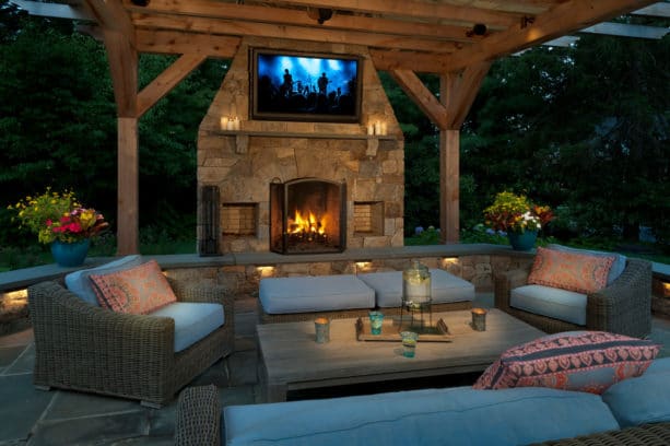 contemporary patio with outdoor stone fireplace and tv