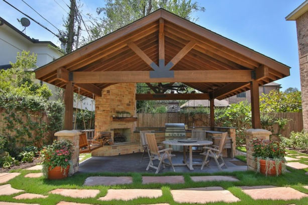 rustic concrete covered patio with masonry wood burning fireplace