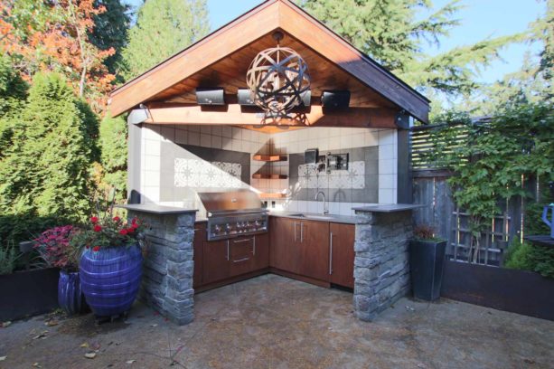 small modern covered outdoor l-shaped kitchen in an open concept design