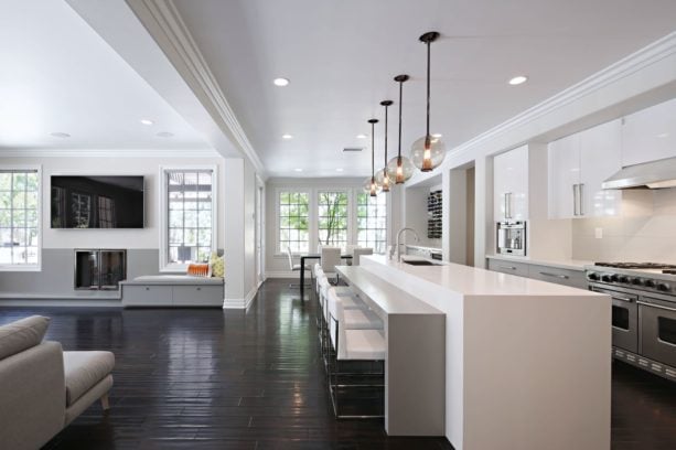 dark distressed maple engineered wood floor combined with white kitchen cabinets and backsplash