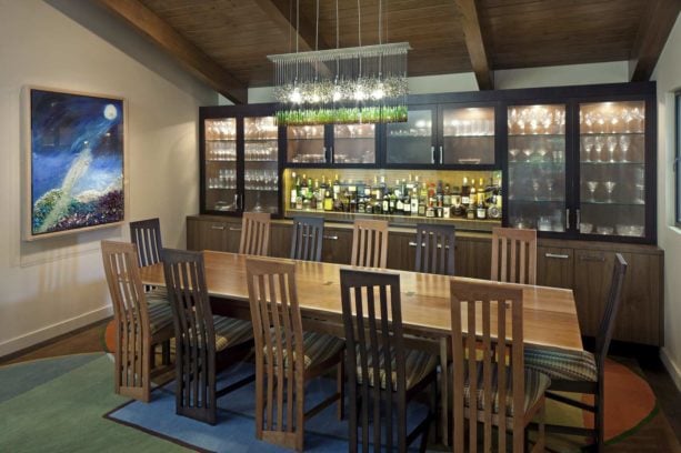 mid-century dark color dining room with long cabinet in a dry bar