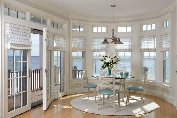 sheer fabric roman shades window treatment of a french door opening to a patio