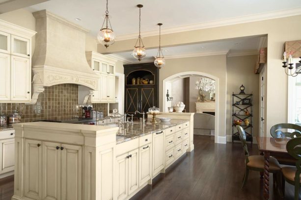 traditional kitchen with dark tone wood floor and creamy white cabinets