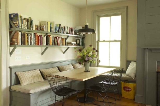 a built-in seating and casual pedestal dining table as a desk