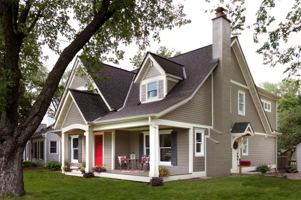 black timberline roof with beige trim color in a traditional house exterior