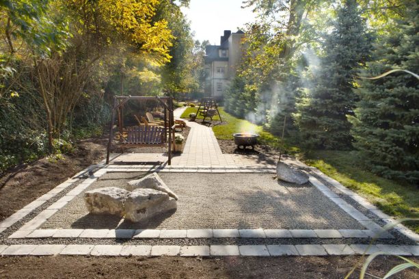 bordered rock garden connected to the paver-lined walkway without plants