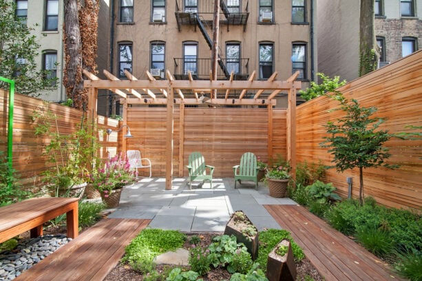 contemporary townhouse patio with a pergola