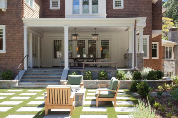 a raised small back porch that is connected to the patio