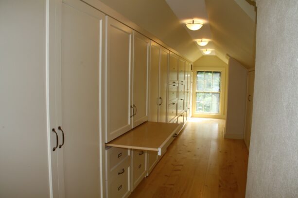 combination of white and wood elements in an attic closet