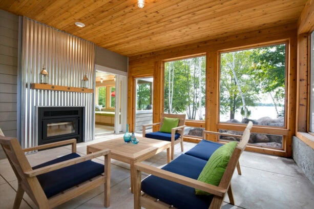 fireplace with corrugated metal steel surround and a wood mantle