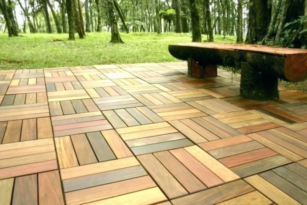 composite interlocking patio tiles on grass in the backyard