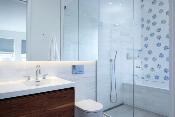 a girly bathroom with white wall combined with blue floral patterns as its accent