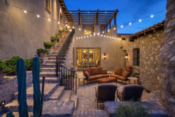 lovely cocktail courtyard in stone exterior spanish style home