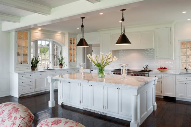 arched windows over an undermount sink in a traditional kitchen