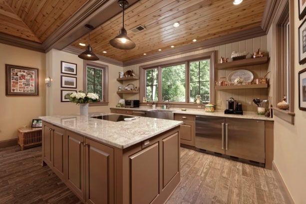 beige kitchen color mixed with light brown raised-panel cabinets to achieve a homey feeling