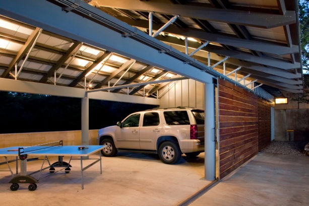 medium tone wood side sliding door in an industrial garage