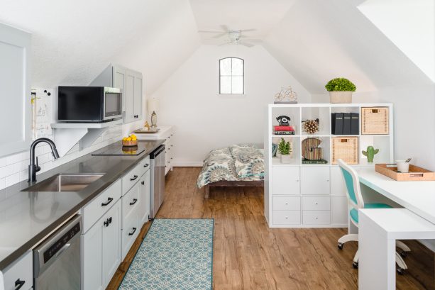 white ikea shelf as a functional room divider in an attic studio apartment