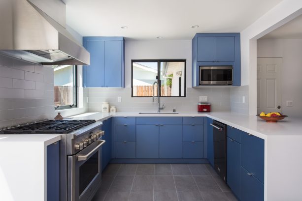 gray kitchen floor tile with white grout and trendy blue cabinets