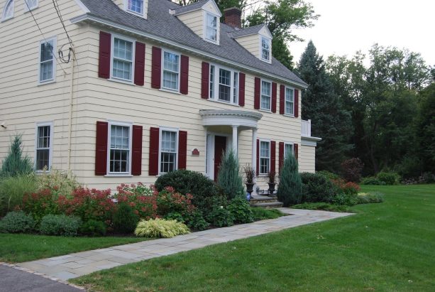 deep red shutter color that goes with a yellow house