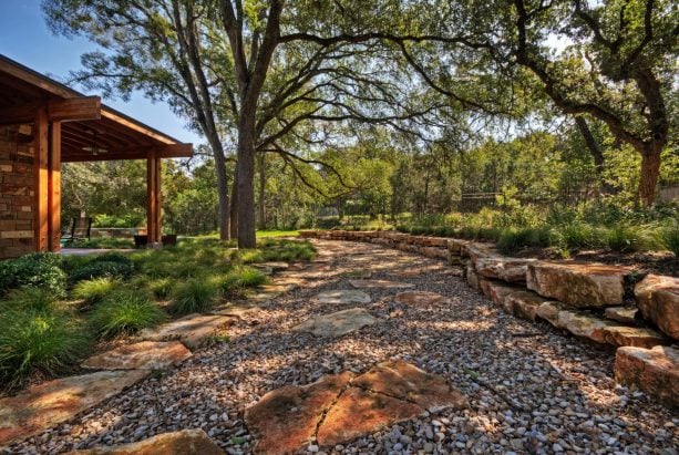 contemporary river rock garden path that doubles up as drainage