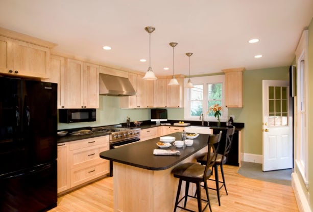 a traditional kitchen with natural maple cabinets and Kittery Point Green wall paint